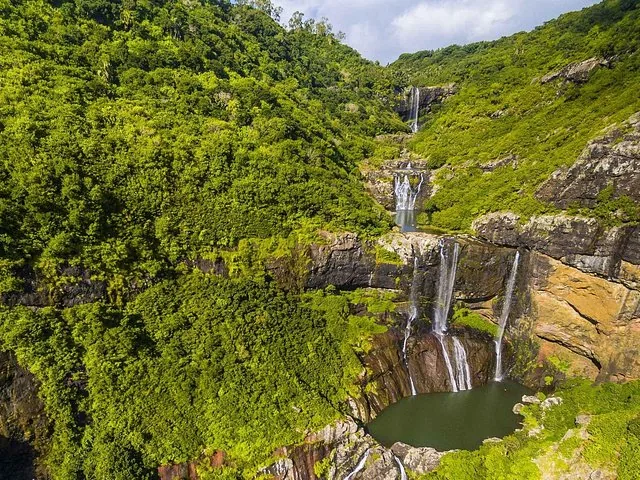 Aerial view of multiple cascading waterfalls at Tamarind Falls amidst lush greenery
